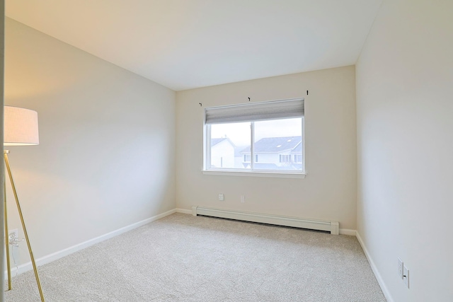 unfurnished room featuring baseboards, a baseboard heating unit, and carpet