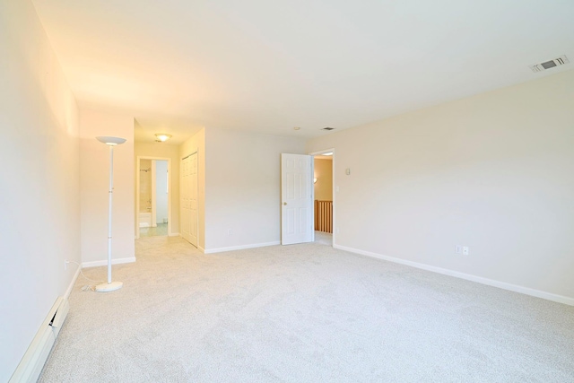 unfurnished room with visible vents, baseboards, and light carpet