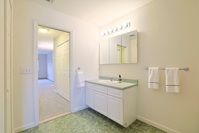 bathroom with vanity, visible vents, and baseboards