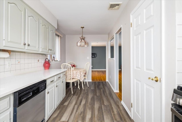 kitchen with dark wood-style floors, baseboards, stainless steel appliances, decorative backsplash, and light countertops