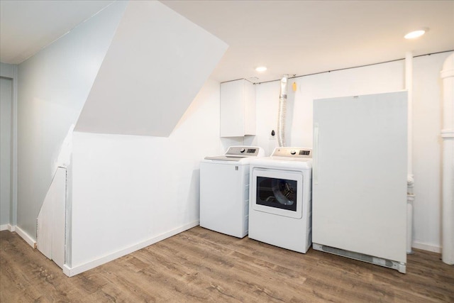 washroom with light wood finished floors, baseboards, laundry area, recessed lighting, and independent washer and dryer