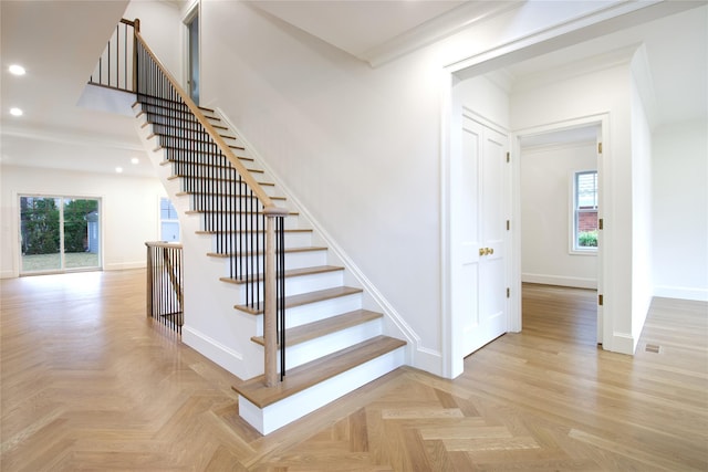 stairway with recessed lighting, baseboards, and ornamental molding