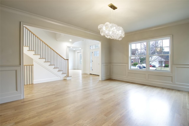 interior space with stairs, crown molding, and a decorative wall