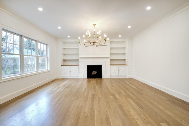 unfurnished living room featuring baseboards, a chandelier, and crown molding