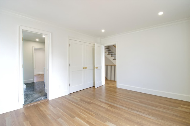 unfurnished bedroom with crown molding, recessed lighting, light wood-style floors, and baseboards