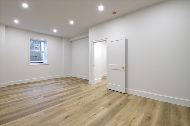 spare room featuring recessed lighting, light wood-style flooring, and baseboards