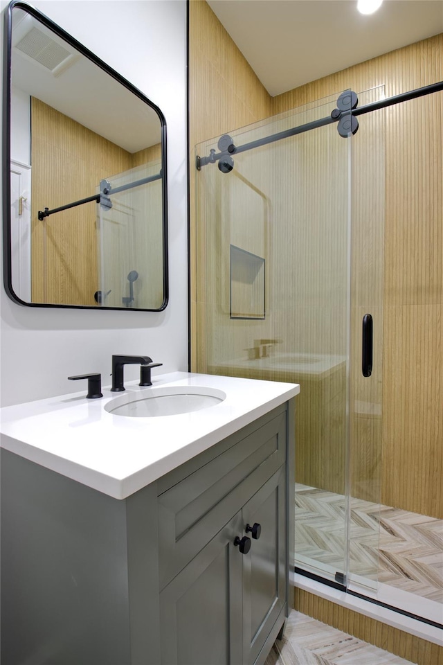 full bathroom with vanity and a stall shower