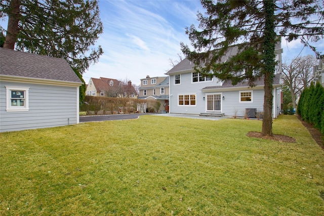 view of yard featuring fence, central AC unit, and a patio area