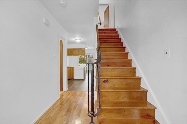 stairs with baseboards and hardwood / wood-style flooring