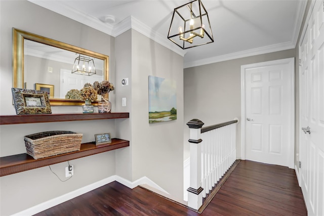 hallway featuring dark wood-type flooring, crown molding, and a chandelier