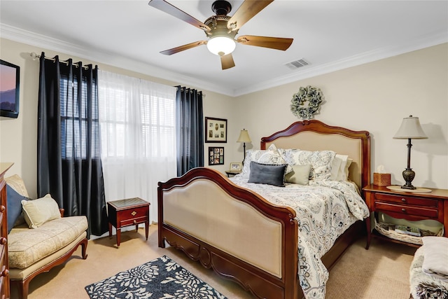 carpeted bedroom featuring visible vents, ornamental molding, and a ceiling fan