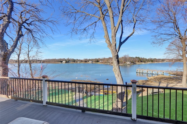 wooden terrace with a lawn and a water view