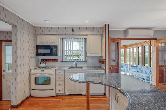 kitchen with gas range gas stove, black microwave, dishwasher, a wall mounted AC, and a sink