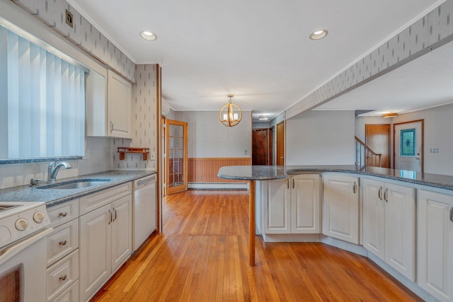 kitchen with white electric range, a baseboard heating unit, wainscoting, dishwasher, and a chandelier