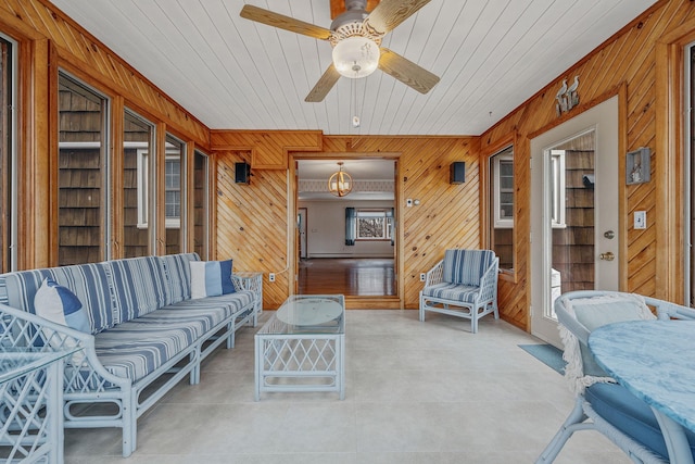 sunroom with wooden ceiling and ceiling fan