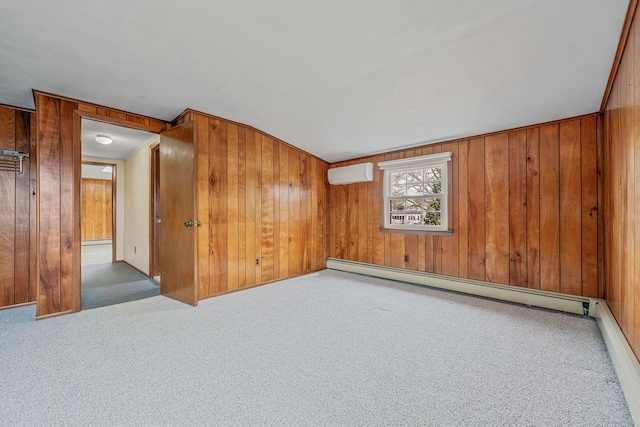 empty room featuring a baseboard radiator, wood walls, carpet flooring, and a wall unit AC