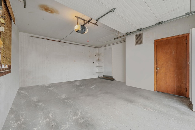 garage with a garage door opener and visible vents