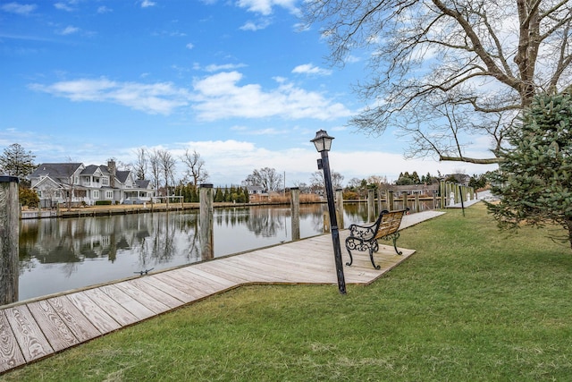 dock area featuring a yard, a water view, and a residential view