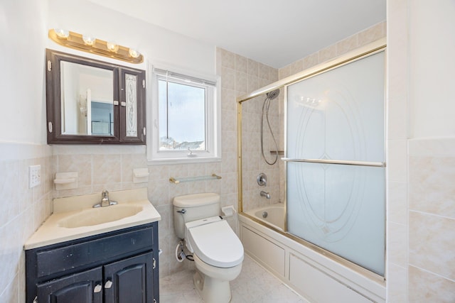 bathroom featuring toilet, shower / tub combination, tile walls, tile patterned flooring, and vanity