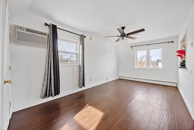 spare room featuring a healthy amount of sunlight, wood finished floors, ceiling fan, and a baseboard radiator