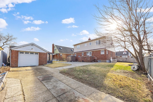 view of front of property featuring brick siding, an outbuilding, a front yard, and fence