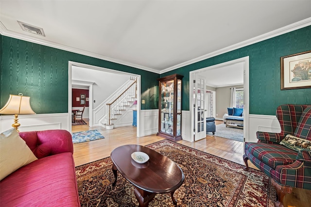 33 Sutherland Dr, Highland Mills, NY 10930 - living area with wood finished floors, stairway, wainscoting, french doors, and crown molding