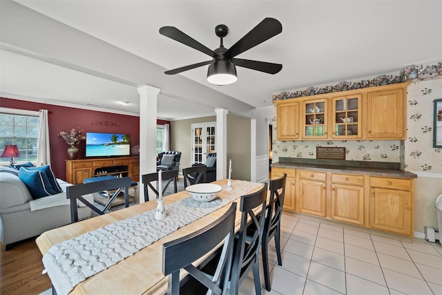 33 Sutherland Dr, Highland Mills, NY 10930 - dining space with ornate columns, a ceiling fan, a fireplace, and wallpapered walls