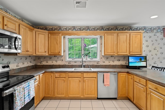 33 Sutherland Dr, Highland Mills, NY 10930 - kitchen featuring stainless steel appliances, a sink, dark countertops, wallpapered walls, and light tile patterned flooring