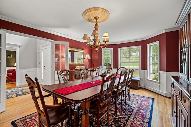 33 Sutherland Dr, Highland Mills, NY 10930 - dining space featuring a chandelier, light wood finished floors, ornamental molding, and a wainscoted wall