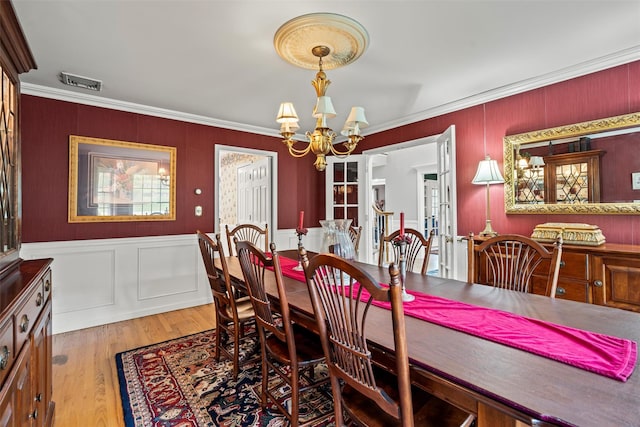 33 Sutherland Dr, Highland Mills, NY 10930 - dining room with a chandelier, crown molding, wood finished floors, and a decorative wall