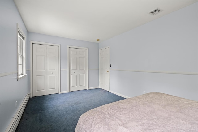 33 Sutherland Dr, Highland Mills, NY 10930 - unfurnished bedroom with a baseboard heating unit, two closets, carpet flooring, and baseboards