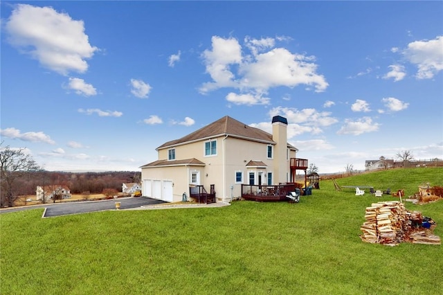 11 Dorian Way, Campbell Hall, NY 10916 - rear view of house featuring an attached garage, driveway, stucco siding, a deck, and a chimney