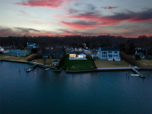 aerial view at dusk with a water view