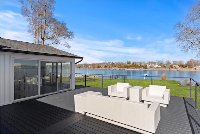 deck with outdoor lounge area, a water view, and a lawn
