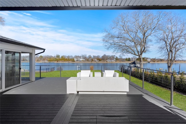 deck featuring a water view, fence, and a yard