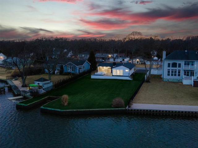 drone / aerial view with a residential view and a water view
