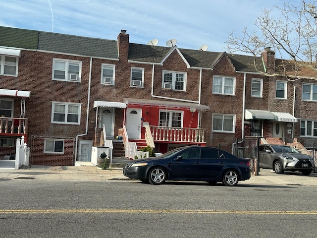 225-23 Murdock Ave, Queens Village, NY 11429 - townhome / multi-family property with a chimney, brick siding, and a shingled roof