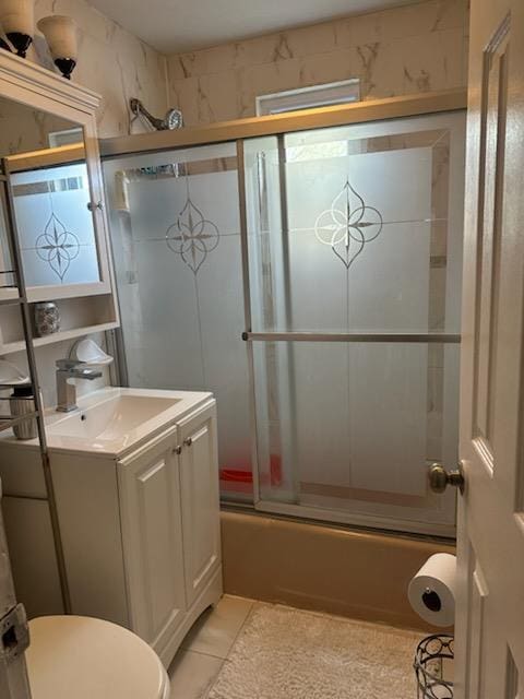 225-23 Murdock Ave, Queens Village, NY 11429 - full bathroom with tile patterned floors, enclosed tub / shower combo, toilet, and vanity