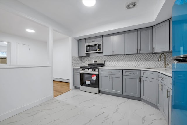 104-65 42nd Ave, Corona, NY 11368 - kitchen with gray cabinetry, marble finish floor, baseboard heating, and stainless steel appliances