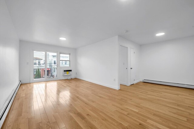 104-65 42nd Ave, Corona, NY 11368 - unfurnished room with light wood-style flooring, heating unit, baseboards, and baseboard heating