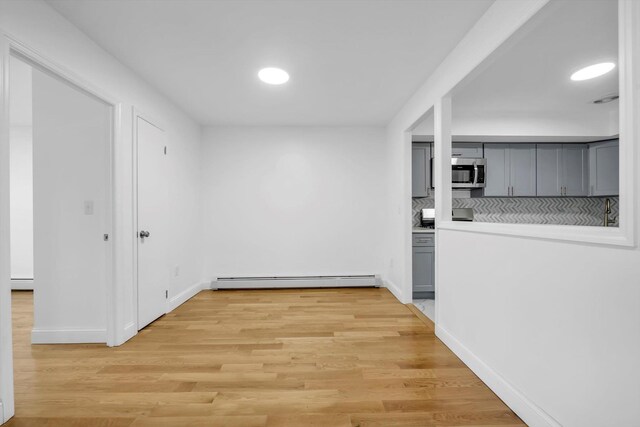 104-65 42nd Ave, Corona, NY 11368 - interior space featuring baseboards, visible vents, light wood-style flooring, a baseboard heating unit, and baseboard heating