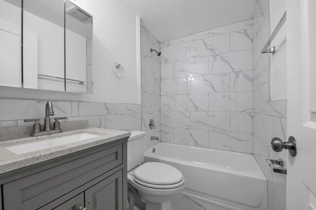 104-65 42nd Ave, Corona, NY 11368 - bathroom featuring vanity, shower / bath combination, tile walls, toilet, and marble finish floor