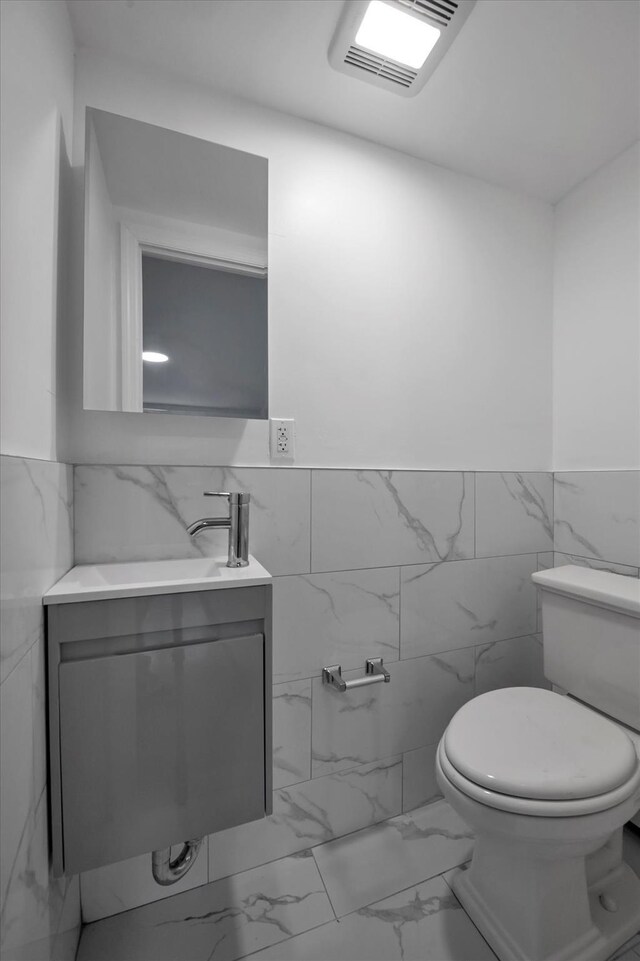 104-65 42nd Ave, Corona, NY 11368 - bathroom featuring visible vents, a wainscoted wall, toilet, marble finish floor, and vanity