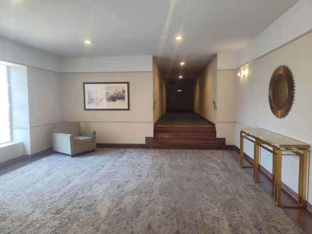67-66 108th St Unit B64, Forest Hills, NY 11375 - unfurnished living room featuring carpet, recessed lighting, and baseboards