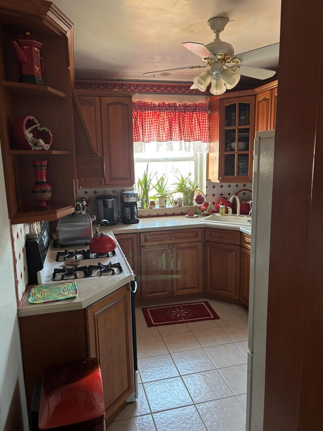 67-66 108th St Unit B64, Forest Hills, NY 11375 - kitchen featuring a sink, white appliances, ceiling fan, and light countertops