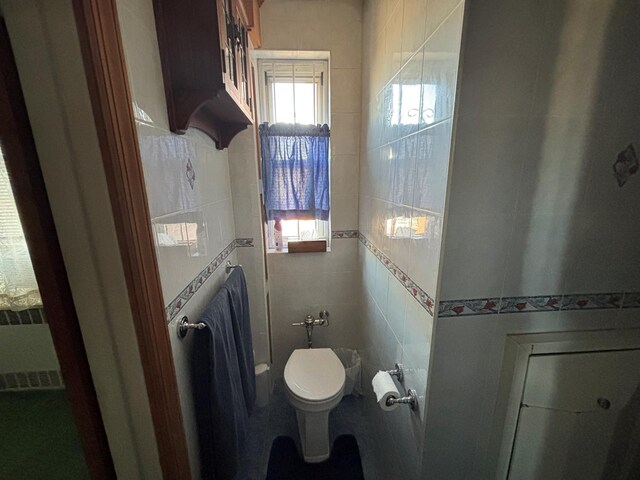 67-66 108th St Unit B64, Forest Hills, NY 11375 - bathroom featuring tile walls and toilet
