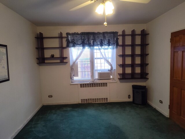 67-66 108th St Unit B64, Forest Hills, NY 11375 - empty room featuring dark carpet, cooling unit, radiator, baseboards, and ceiling fan
