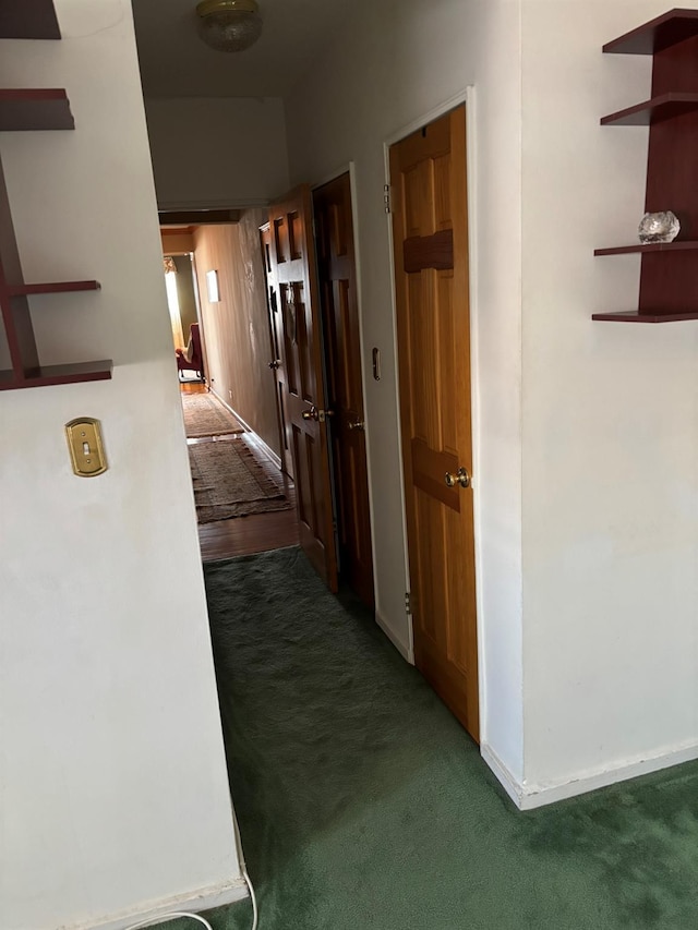 67-66 108th St Unit B64, Forest Hills, NY 11375 - hallway with dark carpet and baseboards