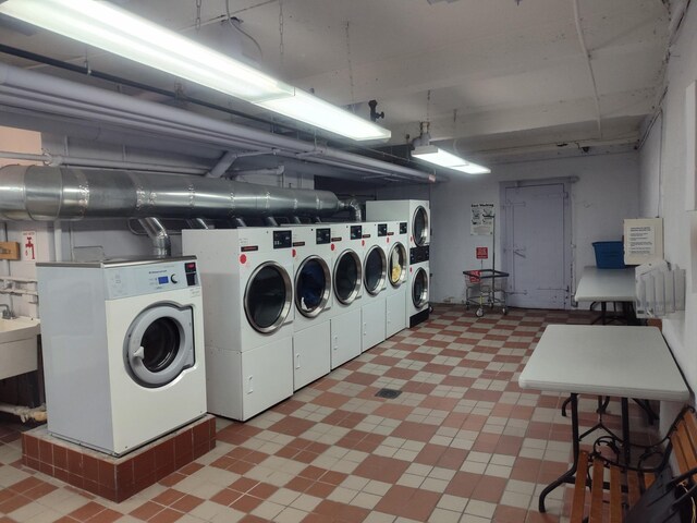 67-66 108th St Unit B64, Forest Hills, NY 11375 - community laundry room with light floors and independent washer and dryer