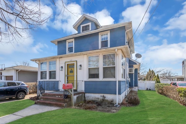 traditional style home with a front yard and fence